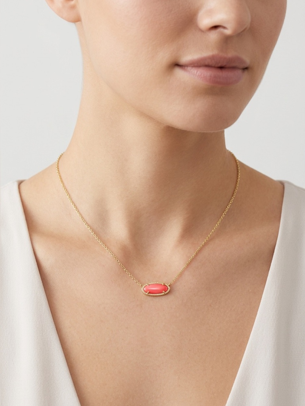 92: Kendra Scott Gold Chain Necklace with Coral Pink Oval Pendant